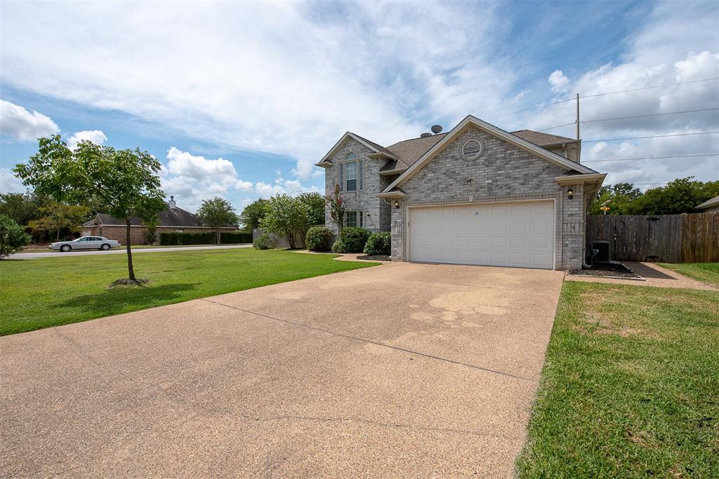 Not only can the driveway comfortably fit 4 cars, BUT, because it's a corner lot, guests can park in front and along the side street.
