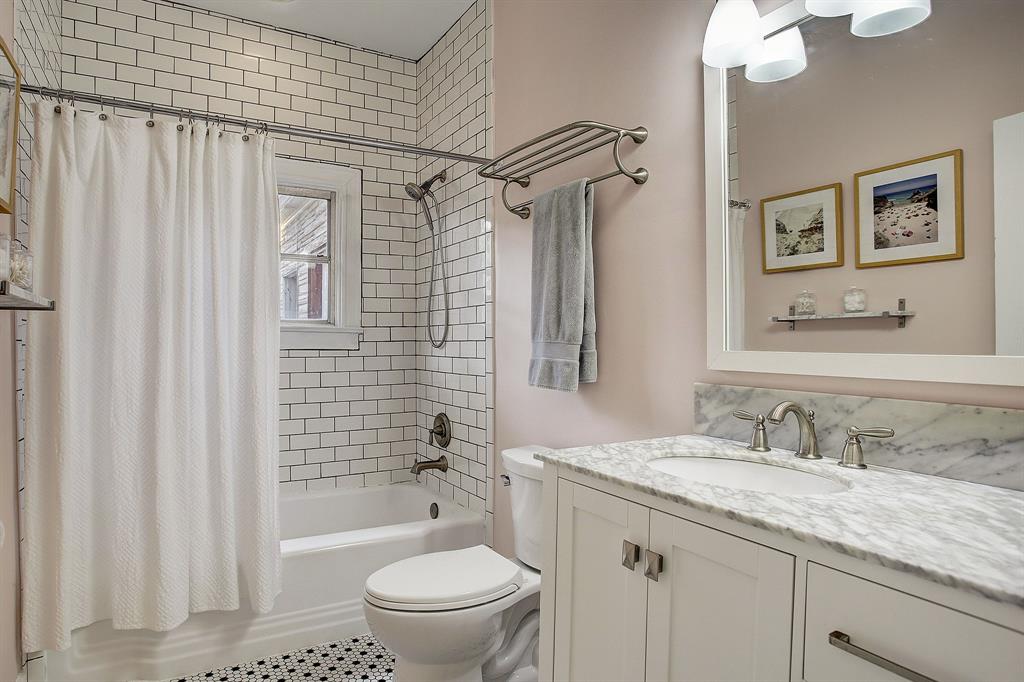 The bath has been thoughtfully updated in the style of the era of the home.  The window in the shower looks out over the back yard.