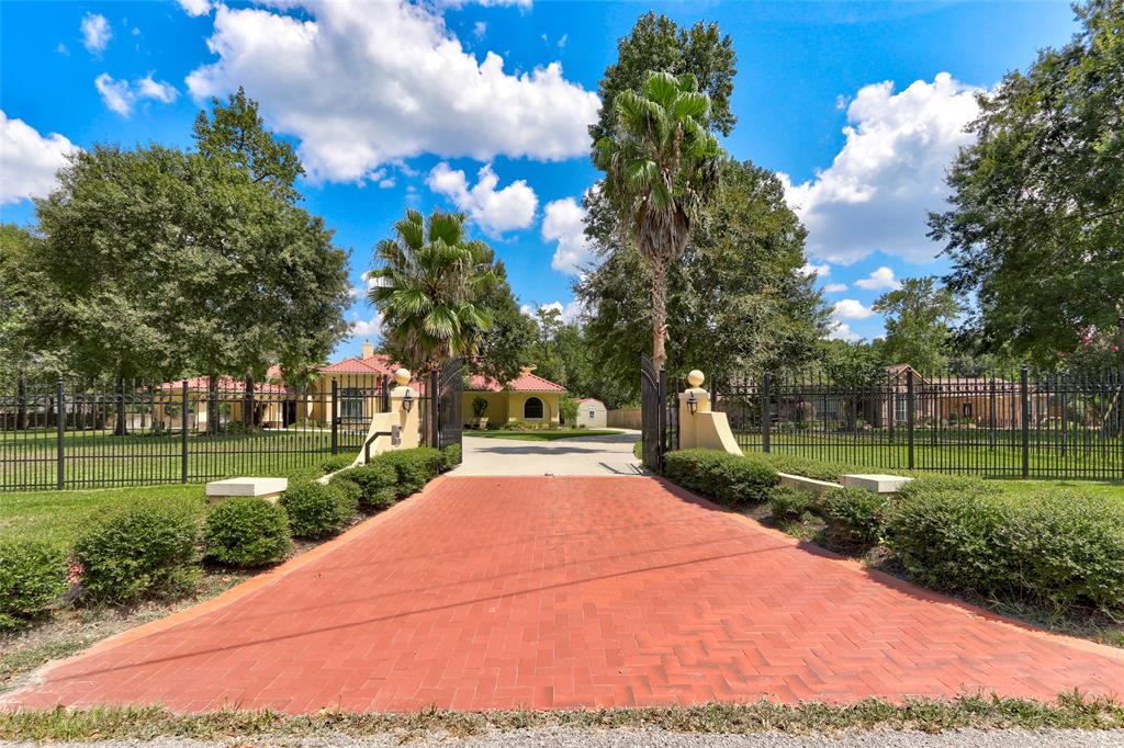 19180 Serpenteer Drive Porter, Texas Stunning Mediterranean style multi-generational home on a fully fenced 1.7 acre corner lot with a private pond. Beautiful hardwood and hard surface flooring throughout (no carpet). The open concept living is perfect for entertaining and both living areas overlook the spacious patio with outdoor kitchen. The spacious kitchen features granite counters, stainless appliances and a breakfast bar all open to the family room with easy access to wine cellar that holds over 100 bottles. Six bedrooms with generous closets. Three car garage with built in storage and an epoxy floor. This is a must see home, located in a secured acreage community with mature trees. The home has two gated entrances and a Porte Cochere. Don't miss out on this dynamite home! NO FLOODING