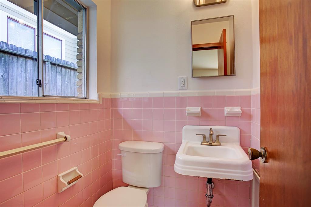 More charm!  This half bath is private to the back/master bedroom.  Also with updated lighting and faucet.