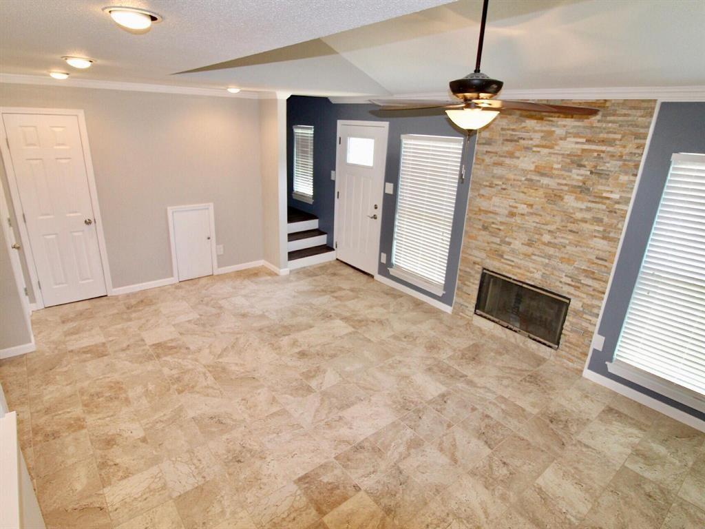 Living room with updated tile flooring and fireplace.