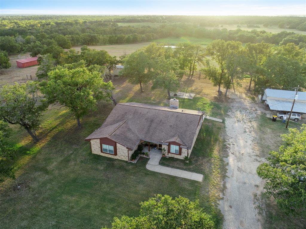 1080 League Line Road Paige, Texas 50+ Acre Ranch nestled in the quiet countryside of Paige, TX! This Ranch is a perfect place to raise your livestock with its fully fenced & crossed fenced improved pastures, cattle guard, plus a Tifton-Hay field & two huge ponds surrounded by picturesque views. Property features a 11x40 Open Barn on 3 sides, a 45x30 Barn w/water & electricity to it, a 15x35 Garage, a 14x28 Storage building sheet-rocked w/AC! 3 car carport, large enough to park an RV w/an RV plug. The spacious 1 story, 3 bedroom, 2 bath, well maintained home offers a formal dining room, a breakfast room & a kitchen w/beautiful Corian counters that opens up to the living room + a large utility room! Updates include: New carpet, faucets, toilet & shower glass in master bath, all new doors & paint throughout! Property has water lines to stock ponds, septic system, public water & electricity. Easy commute to Austin & not far from Houston, Giddings, Smithville & Bastrop. Schedule Your Showing today!