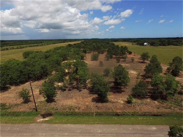 Haynes Double Bayou, Texas Take a drive to this property! You will not be disappointed! Beautiful drive and even more beautiful location!! This property is on a well maintained county road. Property has been mulched and the huge trees have been left to shade your future home site. The driveway to the left of the property is lined with amazing, mature oak and cedar trees!