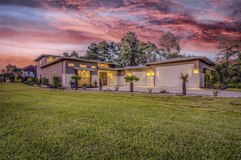 27303 Owosso Court Spring, Texas Welcome to this amazing contemporary custom home built in 2017 with polished concrete flooring throughout 1st floor, 4 spacious bedrooms, 4 full baths with floating vanities, commercial refrigerator, quartz island with seating for 4, dining area, next generation feel with two bedrooms downstairs and a full bath with walk in shower in proximity to downstairs guest room. Master includes two vanities, large walk in shower with two shower heads, amazing bathtub and huge closet. The patio adjacent to the living area is separated by full wall sliding doors that lead from the living are to the patio with a built in grill, sink and fridge, then to the outside through full wall sliding doors where you will enjoy a sunken fire pit with stone seating. Upstairs includes 2 bedrooms and 2 full baths, workout area/game room and media room with starlight ceiling. All of this beauty sits on 1.1 acres of lush green space. The garage is enormous with sink and bathroom with built in air compressor lines.