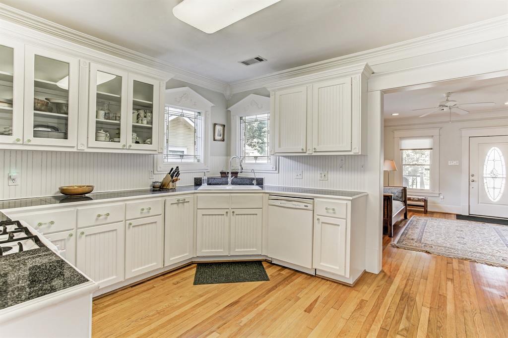 Two windows over the sink with a street view and glass front cabinets are a bonus!