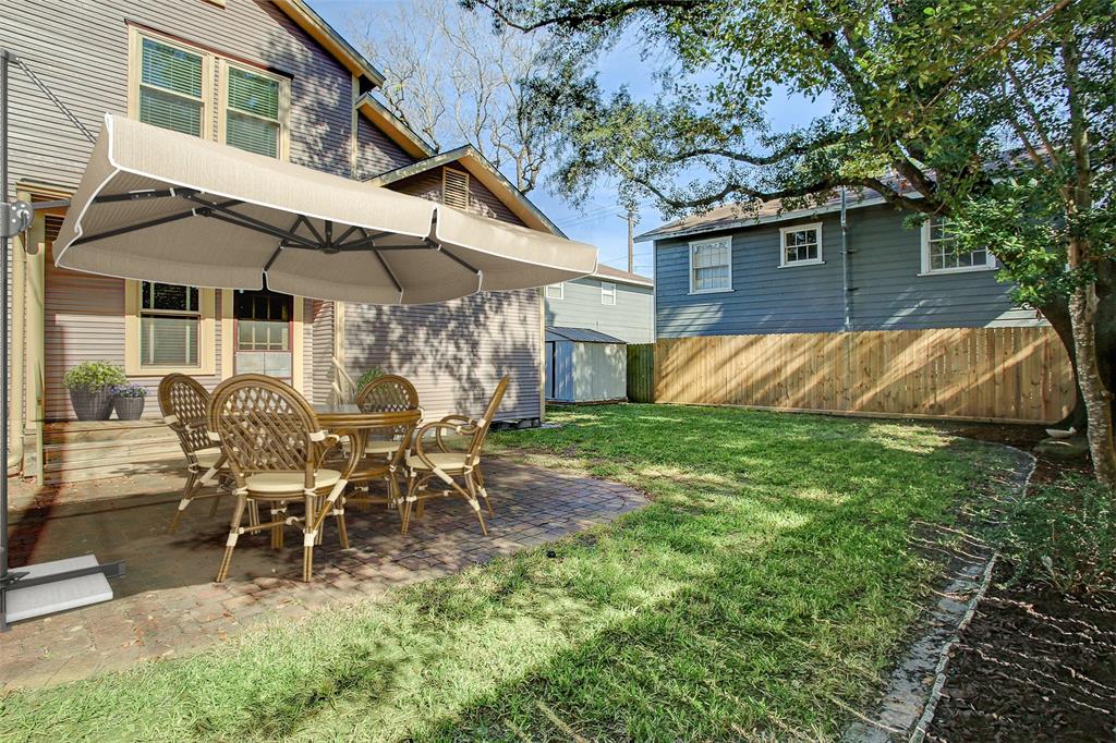 The paver patio in the back yard is spacious and can handle a number of furniture arrangements.  (This space has been virtually staged.)