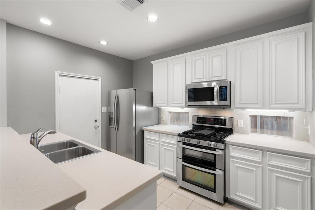 Double oven, refrigerator, dishwasher, and built-in microwave included in the kitchen.