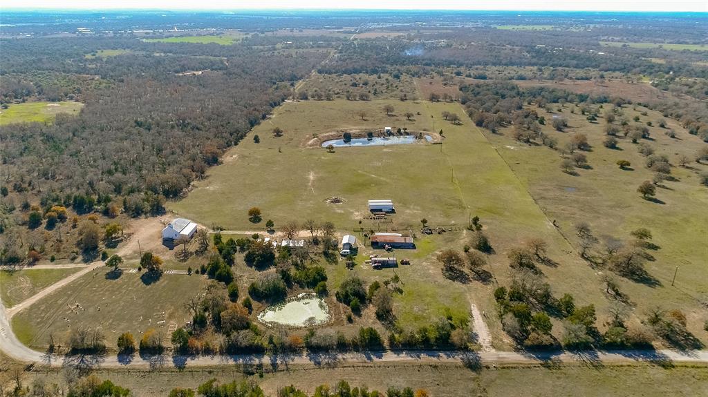 000 County Road 133 Giddings, Texas 25.7 acres in Lee County with easy access from Hwy 290. If you want your own working ranch, this is the whole package! Completely fenced and some cross-fencing. Includes a barn, hunter house, small cabin overlooking one of the 2 ponds, livestock trailers, tractors and all implements and farm equipment. Cattle and cattle equipment are also included! Get around the property on the Trx450fm four-wheeler. Two 48 foot storage trailers are full of parts and tools and an additional trailer used as a shop already hooked up with electric. 2015 RV hooked up and ready to move in and a Mark III van. New aerobic septic system. Two electric service meters, 3 gated points of entry. Mature trees scattered over the property. No restrictions. AG exempt. Minerals negotiable.
