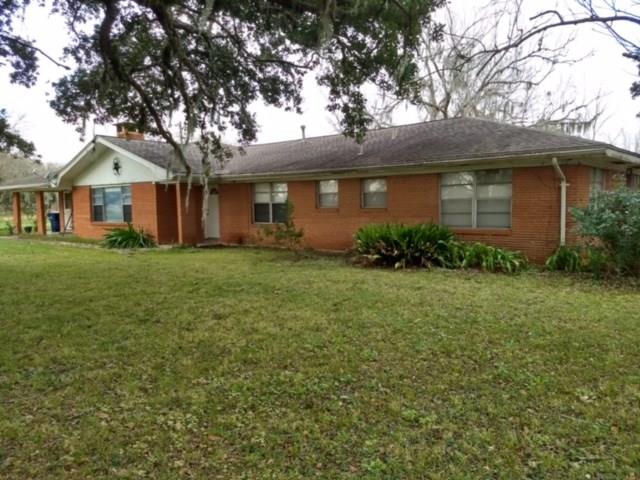 11539 Fm 457 Cedar Lane, Texas Looking for Land, here it is your Oasis awaiting/16 acres of beautiful scenery in such a quiet low key area. Wildlife is abundant for hunting,great pasture land for horses & cows.A bonus on this land is a large traditional ranch style home.The house is brick outside w/wood trim.The interior of house needs some TLC.There are 2 Living areas separated by a fireplace accessible from both sides.The formal dining room is open to main living area & main entry way.The kitchen is large w/lots cabinet space & a small breakfast nook,w/doorway open to the garage another entry point.There is also a back exit from the home through the formal dining area.The home has 4 large bedrooms which 3 have their master bathrooms.The closets in all rooms have lots of room for storage & more.There is a half bath in the utility room as well.Again home is in need of some repairs & TLC, & parts previously flooded during Harvey taking on only about 1/2 in some rooms.Foundation repairs needed as well due to flooding.