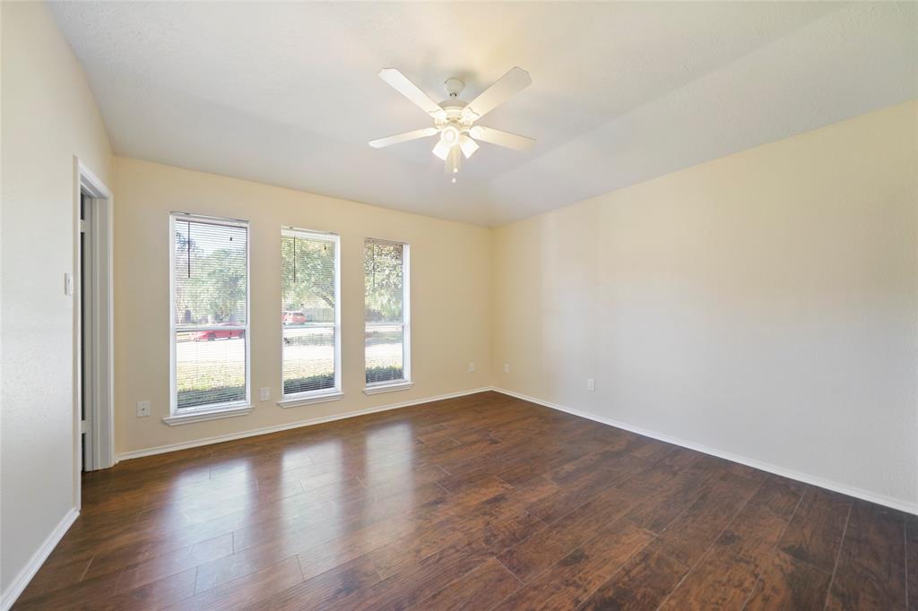 Master bedroom is located at the front of the house with beautiful laminated wood floors.