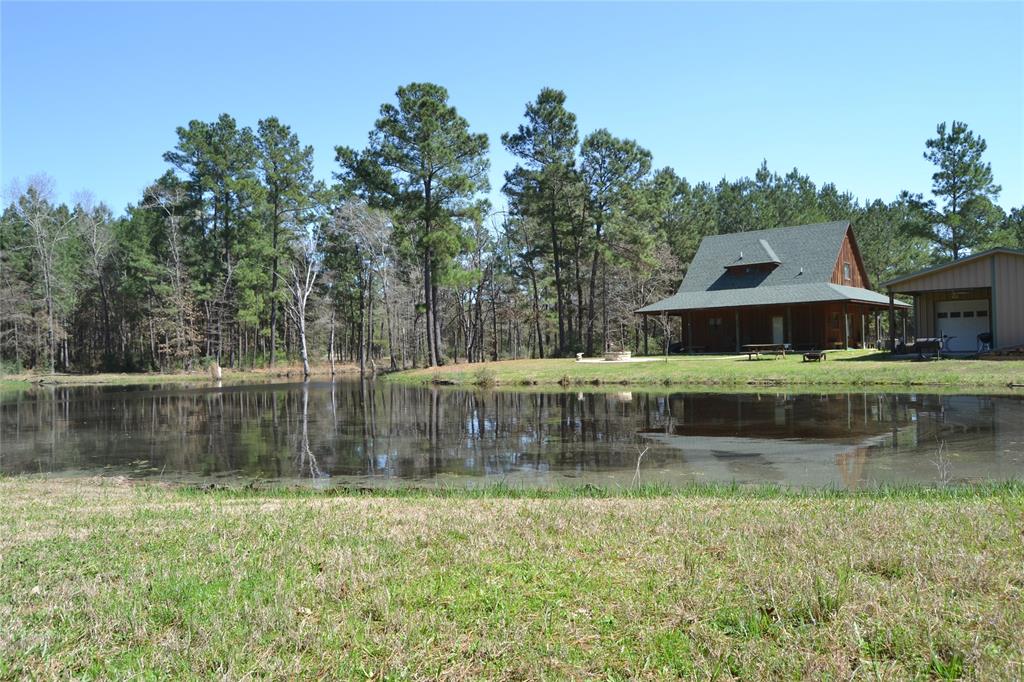 8188 County Road 3375 Crockett, Texas BEAUTIFUL COUNTRY SETTING!
This three bedroom, two bath home has lots of extras! The home sits on 10+ mostly wooded acres overlooking a nice lake. Downstairs, you will find an open concept living, dining, and kitchen area. The master bedroom, bath, and laundry room are also downstairs. Upstairs, there are two nice size bedrooms and a bath. This home is equipped with a security system. The wrap around porches offer great views of the lake, woods, and wildlife. The two-car garage has a covered area for additional parking. Behind the garage, there is a bonus guest room with bath. This property is fenced and has frontage on both, CR 3375 AND CR 3385. Come see this great home today!
