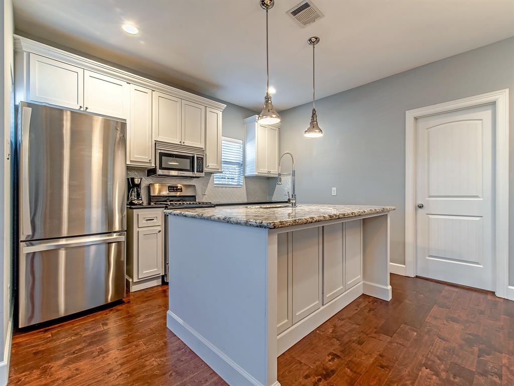 This kitchen does not disappoint with top of the line appliances (Bosch and Kenmore Elite) custom built-in cabinets, black granite and generous marble island with breakfast bar and under counter storage.