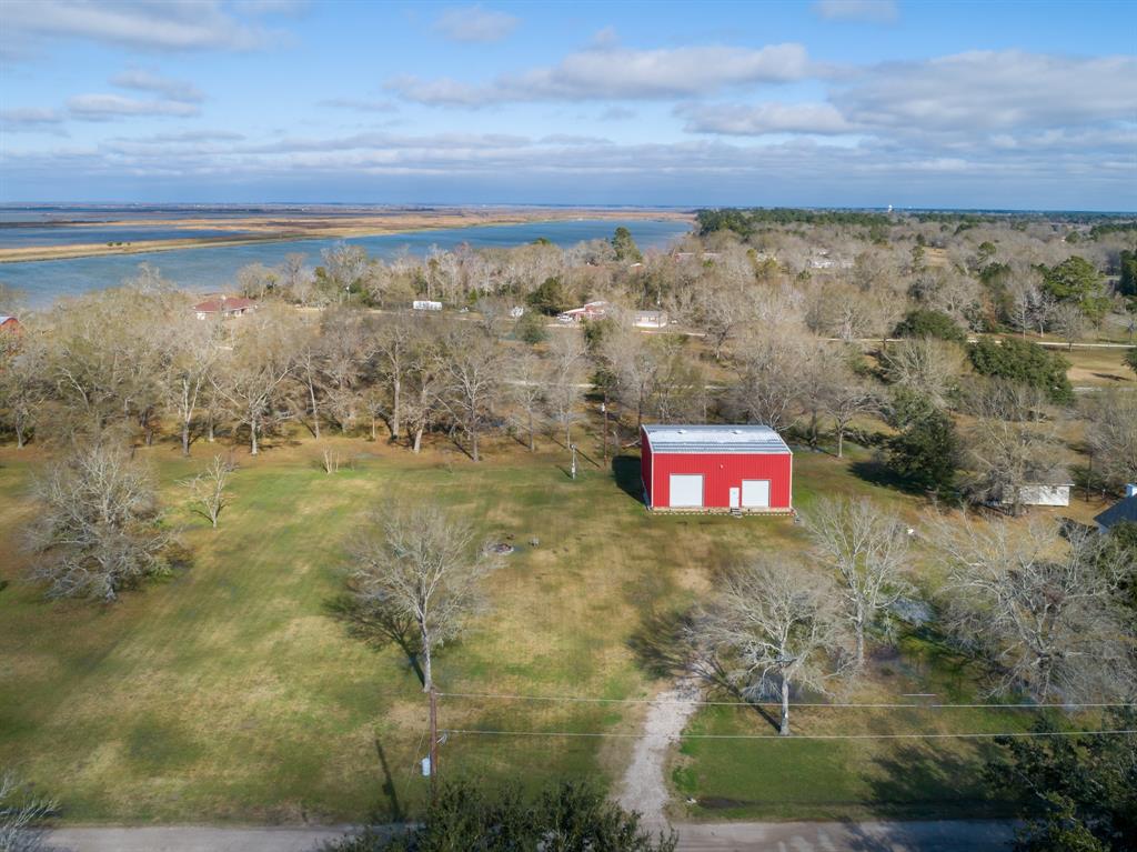 188 Garvey Road Anahuac, Texas Looking to build your dream home in Anahuac? This great property consists of two tracts (1.1 acres) with views of the Trinity Bay and includes a 50ftx40ftx26ft, 2-story metal insulated building with (2) roll up bay doors on a 3 foot slab. The building is equipped with 24 hour surveillance camera, water, sewer and electric to supply the buildout to a barndominium, RV storage (hookup accessible) or shop and still have plenty of room to build your dream home on this gorgeous piece of property! Boat launch is 1/4 mile away. Enjoy bonfires under the beautiful Texas skies with the concrete burn pit. A culvert and temporary driveway have been added for easy accessibility. The property is located outside the Anahuac city limits, just minutes away from Galveston and Trinity Bay. Also, just a 1/4 mile south of the Annual Texas Gator Festival. This a hunters and fisherman's paradise. Crystal Beach and the Boliver Peninsula are just a short 30 minute ride through the back roads.