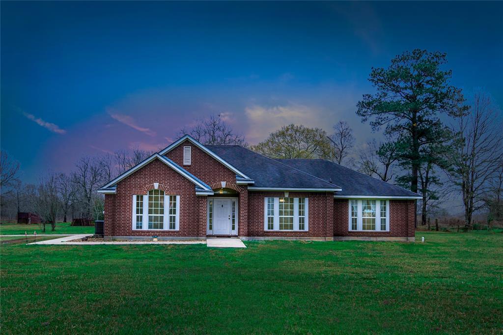 15822 Highway 146 Liberty, Texas Nestled on over 20 acres, this country dream property has so much potential. Gorgeous brick wraps around the exterior and leaves a wonderful first impression. As you step inside, notice the neutral palette enhanced by the natural light pouring in from each window. A cozy fireplaces adds character to the living room. The charming kitchen with lovely oak cabinetry features an island and plenty of space to prepare your favorite recipes. Enjoy gathering at the breakfast nook/dining room. More seating can be found at the breakfast bar. Generous bedrooms and spa-like master bathroom.
