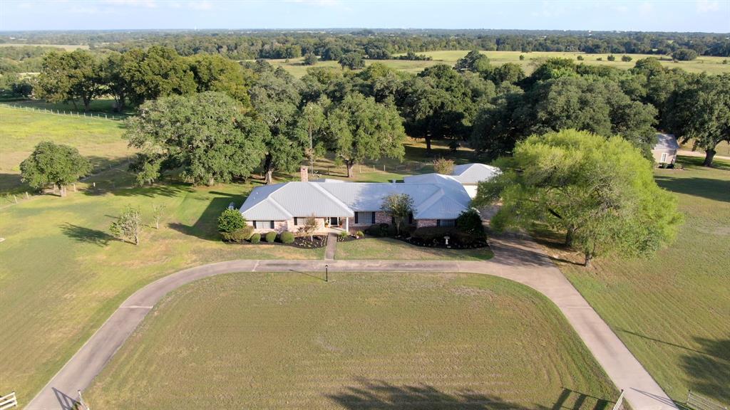 6841 Mount Vernon Road Burton, Texas This is the one you've been looking for! Updated immaculate ranch style home featuring 4-oversized bedrooms, 4-baths, approximately 3403 SF. With a large family room, formal living and formal dining there's plenty of room for those family celebrations. The recently updated kitchen is the perfect layout for entertaining.
1890's Farmhouse- This 1-bedroom, 1-bath completely restored and move in ready is a great guest house. Spend a lazy afternoon swinging on the front porch or you evenings on the enclosed back porch. This farmhouse has also been used as an Air BNB and a rental home so it offers the opportunity as an income producing property.
Land-Beautiful 8+/- acres with some of the largest live oaks I've seen in Washington County. This park like setting is an amazing area to take advantage of the peace and quiet of the country setting. Additional barns and sheds are also available for storing your tractors or ATV.