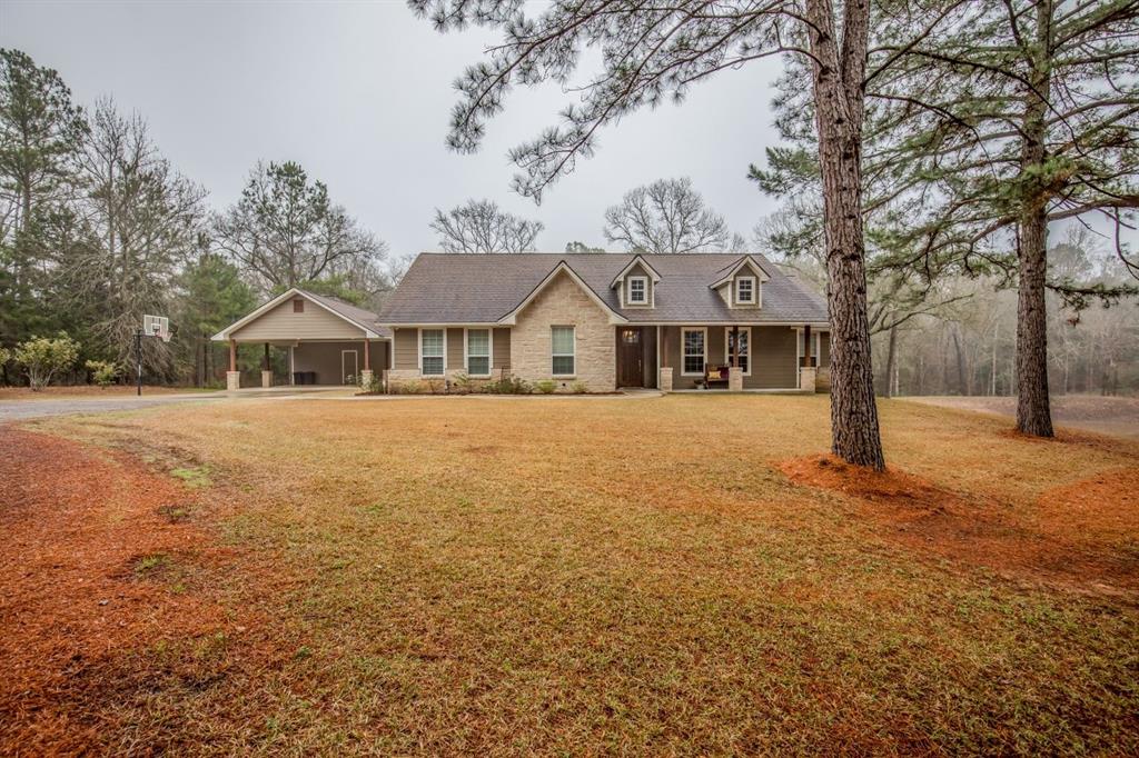 307 Pr 12 Centerville, Texas This BEAUTIFUL custom home on 5 acres with a pond is a must see! Pulling into the circle driveway you'll see the 2011 concrete-siding and stone home tucked back on a hill with a welcoming front porch that exudes country hospitality. Enter through the foyer into the open concept living, kitchen and dining areas with high ceilings, large trimmed windows, beautiful stained concrete flooring, granite countertops, specialty lighting fixtures, stainless appliances, large breakfast bar, and stone gaslog fireplace. The enviable master bedroom is spacious with a tray ceiling, room for a sitting area, huge walk-in closet and serene private bath with soaking tub and separate tile walk-in shower. Additional guest rooms are ample and feature walk-in closets and a bathroom with two private vanities. Other amenities include a convenient half bath, walk-in pantry, utility room, and attached carport with storage. Enjoy the view of the pond and the woods from the covered back porch. Don't miss this one!
