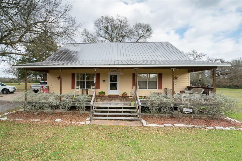 5745 Fm 2289 Normangee, Texas If you are ready to move to the country, this Picturesque Ranchette in Normangee, Madison County on 10.5 acres may be it. This custom Hardi Plank home features 2 bedrooms, spacious loft, 2 full baths and 2 car detached carport. The kitchen has custom cabinets with antique old world glass facing, island and walk in pantry, the first floor has high custom ceilings, a spacious loft and there are beautiful front and back porches for drinking coffee and viewing wildlife. Other features include an adorable 624 SF Cabin that functions as a guest house, a 30x30 workshop, catfish and blue gill stocked pond with pier, automatic driveway gate, and paved road frontage. The acreage is approximately 40% open and 60% wooded presenting with a regular shape and a mixture of hard and soft woods. Make this your full time residence or a weekend retreat.