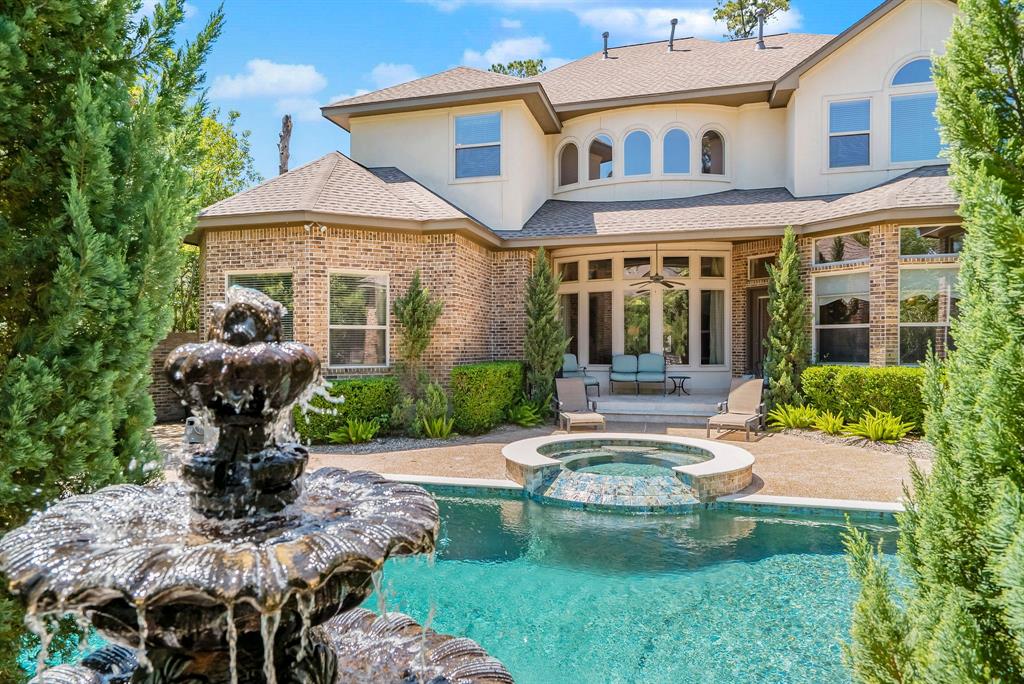 6 Chamberlain Court The Woodlands, Texas Nestled on a cul-de-sac lot in the golf course community of Player Woods,this Tommy Bailey custom is an exceptional blend of thoughtful everyday living and is an entertainer's dream!Stone/brick exterior and stately double doors welcome you!Travertine floors,views of pool & fountain,statement chandelier, & sweeping grand staircase highlight the entry.Formal dining with travertine/mosaic tile accent wall,gorgeous lighting and nearby bar w/wine storage. Wood paneled study with built-ins.Open chef's kitchen with stunning granite island and Thermador appliances.Warm,inviting family room has 2nd fireplace and views of the sparkling pool and outdoor terrace areas. Guest/2nd bedroom down!Private master suite w/built-ins for coffee bar/beverage chiller and glamorous master bath!Huge Gameroom up+4 Bedrooms (one could be Media/Gaming/Ofc).Endless outdoor entertaining options with covered outdoor grill/bar area, glass rock fireplace, & sun lounging!3-car garage & recent roof complete the exterior!