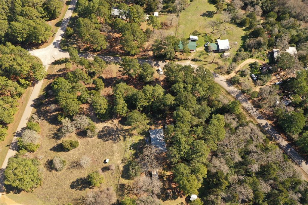 228 Pine Canyon Drive Smithville, Texas Come see this home on a gorgeous 5 acre corner lot. The land has large towering pine trees along with some scattered oak trees. Property features a 3/2 home as well as a refurbished RV that has been turned into a cozy guest quarters. Home is ran on aqua water but also has a functioning well for outdoor watering. Home features a metal roof, hardiplank siding and has no carpet on the inside. Master bath has a large garden tub with a separate shower as well. The energy efficient stainless appliances come to!