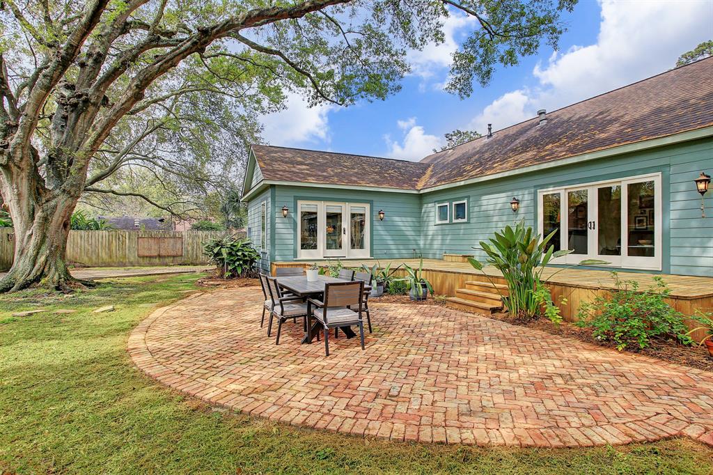 There is so much space to enjoy here, on the brick paved patio or deck. The doors to the left are to the master suite, and to the right to the den.