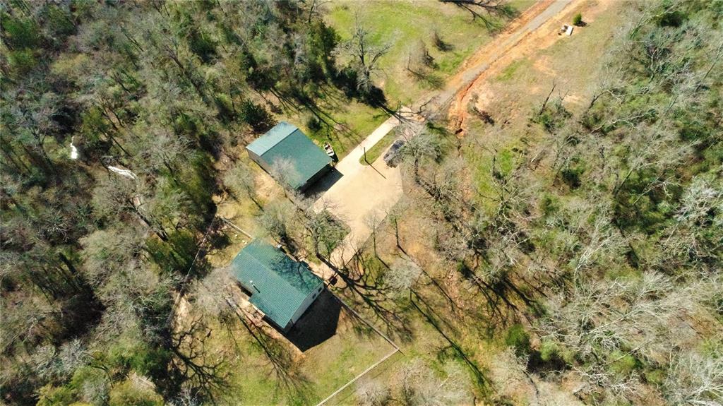16748 Fm 542 Oakwood, Texas This home sits atop a high mesa with a magnificent view of the Trinity River.
31.60 Acres of woods with a 3b/2b Barndominium style home built in 2011 with approximately 2,000 sq. ft. of heated & cooled space. Very nice open concept living/kitchen & dinning room, tile floors through out, large kitchen with tons of cabinet space, wood burning stove and a brand new metal roof.
Other amenities include:
-40x50 metal on metal barn that's fully insulated with a built in apartment, 2 bay doors and 20X50 attached carport.
-Aerobic septic system
-Automatic electric gate
-Over 1,000 feet of Trinity River Frontage
-White tail deer, hogs, ducks
-Pet proof fencing around the back yard
-High fenced garden area
-Large hardwood timber covers the property