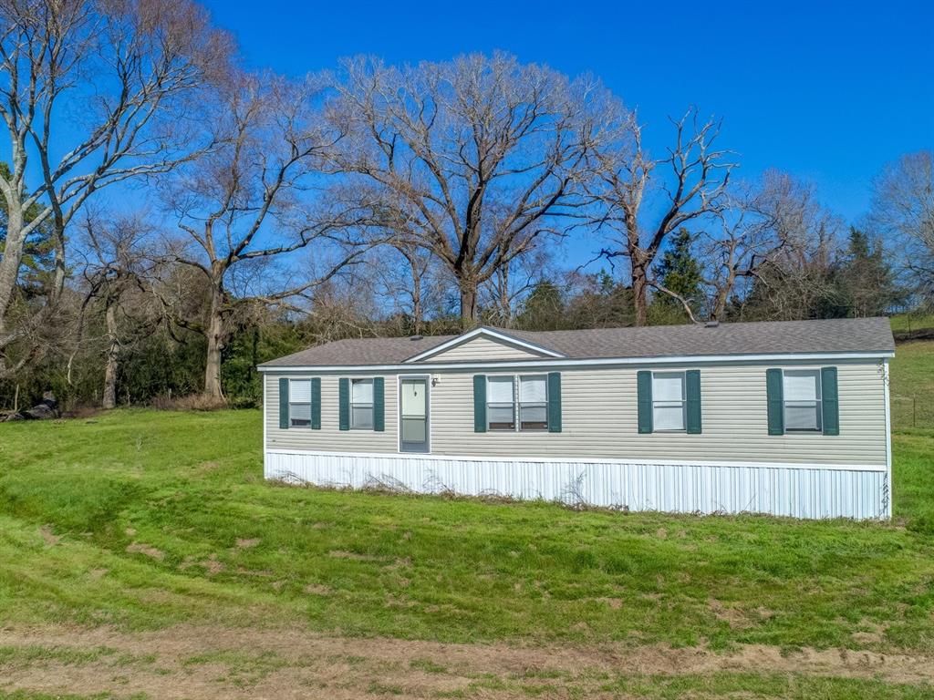 254 County Road 405 Nacogdoches, Texas Looking for acreage? This well maintained home on just under 9 acres in Woden ISD is move in ready. Situated on a quiet dead end road with rolling hills and open pasture. The home offers a split floor plan with a bonus/flex room that works well for a home office or a second living area. Also included is a storage building, canopy and a farm house that could be restored for your forever home or guest house.
