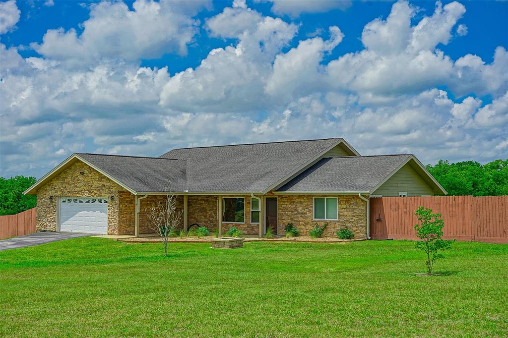 4989 County Rd 447 Anderson, Texas Just outside of Navasota and within easy commuting distance of College Station is this beautiful 1813 Sqft 3 Bed/2 Bath home on 11.7 acres. The 2010 built home features a split, open floor plan with stainless steel appliances, island with bar seating, granite counter tops and large windows to enjoy the long distance hilltop views. Outside both front and back porches are stamped concrete and there is a huge fenced back yard for the kids and dogs to play. The 11.7 Ag exempt acres are ideal for livestock and/or 4-H and FFA projects. Plus there is a 4 car carport, additional septic, storage building, and underground electric. Don't miss your chance to see this move-in ready home today.