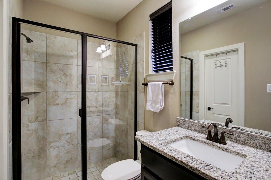 First floor bathroom. Glass walk-in shower, walk-in closet & granite counters & sink all ensuite.