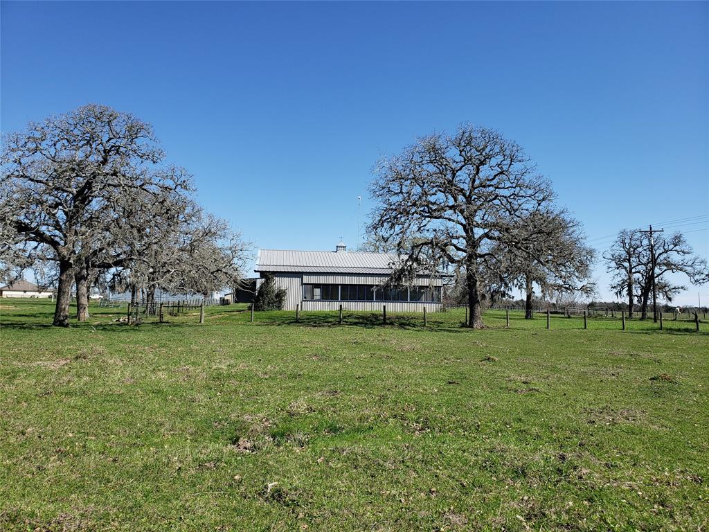 2194 County Road 215 Weimar, Texas This property located South of Weimar in Colorado County would be a nice weekend getaway or permanent residence. The land is just under 20 acres, mostly open with scattered trees. Fences are good and wildlife is plentiful in the area.
The barndominium has approximately 1200 square feet living area, a carport, storage room and lovely screened-in porch facing West towards the pond on the property. This view provides some picturesque Texas Country sunsets!
A large steel frame metal building with 2 tall canopies serves as a nice shop/garage to store vehicles, farm implements, trailers, etc. The shop also has apartment style living quarters with a full kitchen, 2 bathrooms and a utility room.
This property has much to offer and is nearly centrally located within 100 miles from Houston, Austin & San Antonio.