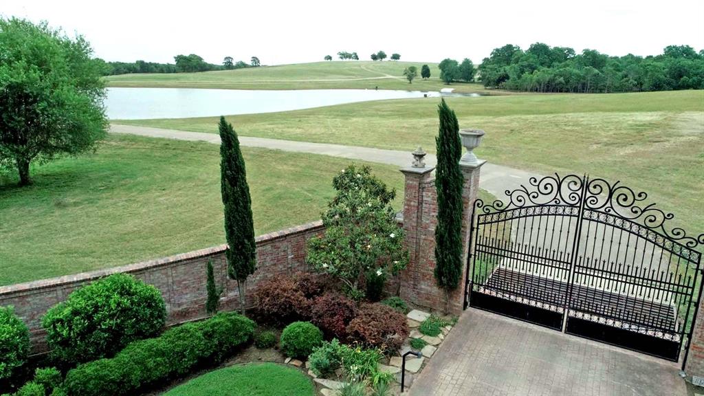 11327 County Road 314 Navasota, Texas Leading into the ranch, you will pass through a beautifully landscaped brick and wrought iron entrance. The electric entrance is equipped with it's own well and irrigation system making the landscaping easy to care for. Just through the elegant gate is the newly rebuilt and stocked approximate 6 acre lake. Feed and fish for large mouth bass from either the bank or take advantage of the boat ramp and reel them in from the middle. The asphalt driveway leads across the dam offering a scenic drive into the ranch highlighting one of the many high points of elevation being offered. The winding drive continues on past numerous large pecan trees and beautiful rolling hills. With 80 foot of elevation change and multiple potential building locations, choosing the perfect home site may take awhile. Comfort will be easy to find in the adorable, newly expanded 1bed/2bath cabin that sits near the middle of the ranch. This ranch boasts some of the most breathtaking long distance views in this region.