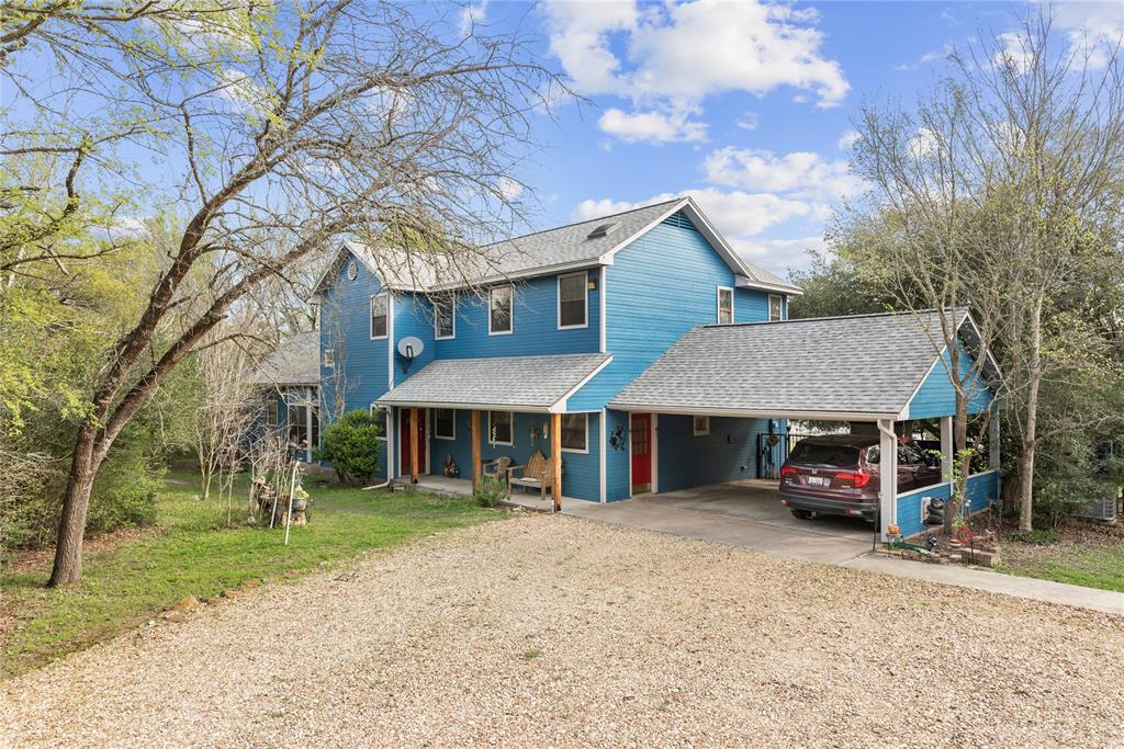 670 Hoosier Lane Navasota, Texas Country living just minutes from town. Enjoy the beauty of this 6.05 acre NWF certified Wildlife Habitat property featuring a spacious 4 bedroom, 3.5 bath home and a lake to while away your time. The home features a large master bedroom suite on the first floor, and second suite upstairs. The kitchen has been recently updated with new granite counters, new appliances, mudroom area, and new flooring in the common areas. Enjoy the views from the lake from inside or from the patios on the first and second floors. A short walk from the home, there's a 1500 sf shop, featuring loft storage and a mechanic's grade automobile lift. The property also includes a 40' RV pad with electric and water hookups. Lots of native trees, plants, and fauna help make this homestead a real treasure. So many wonderful things to love about this property.