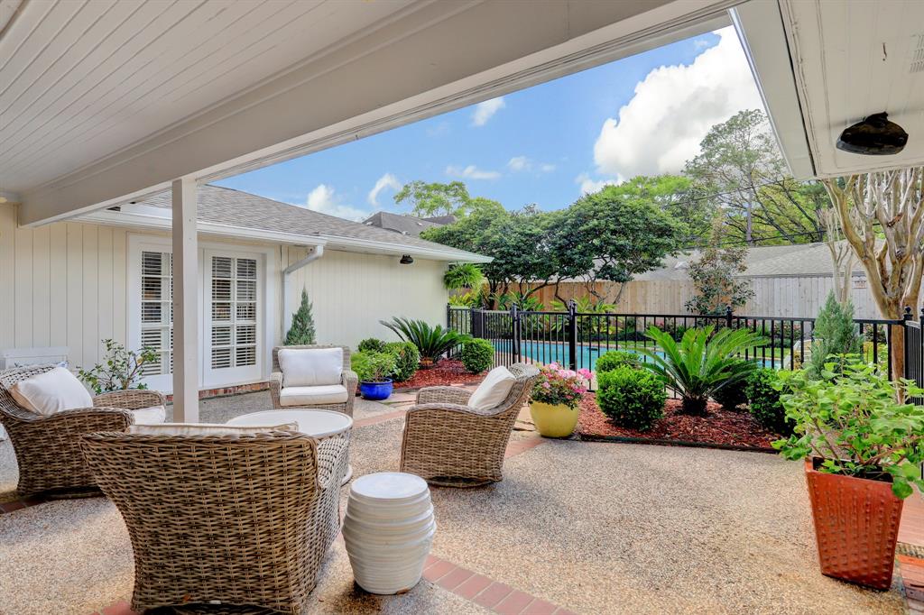 Covered patio outside opens up to the pool area. Pool fence and gate was done in 2018.