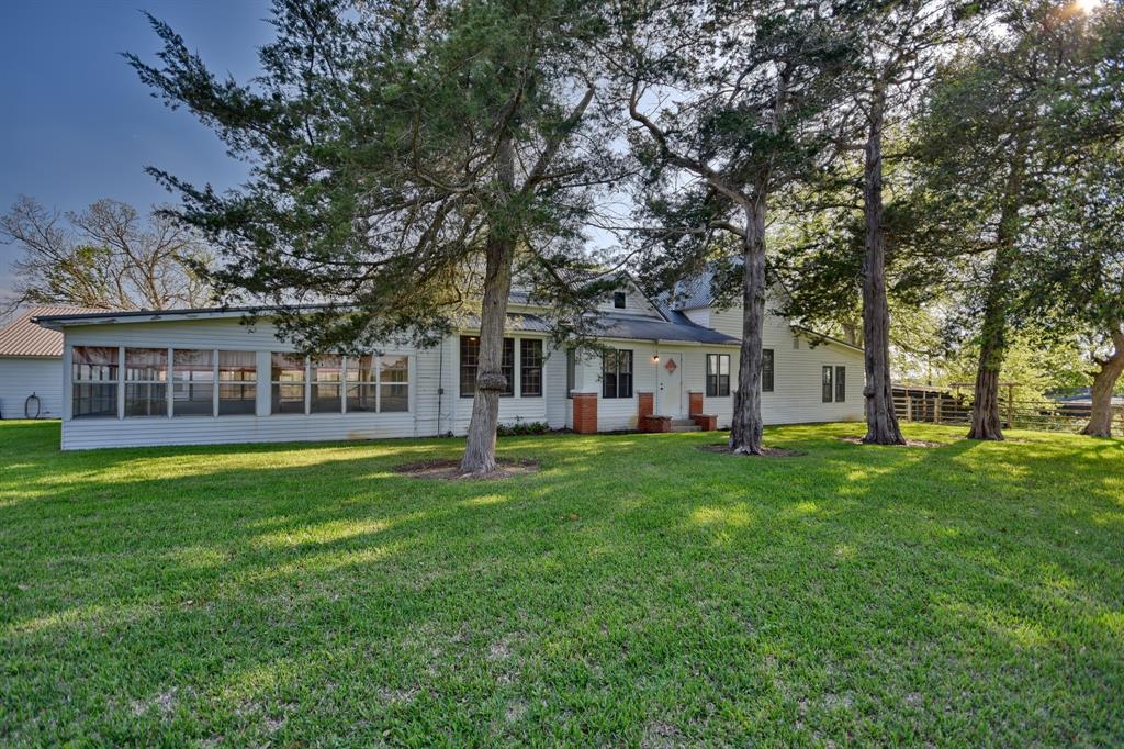 12771 State Highway 159 Highway Bellville, Texas Exceptional Views with Unlimited Potential !! This Classic 1900's Farmhouse sits high on a hill, well off of the paved road with majestic views to the southwest. The property has been in the same family since 1968. Updated in the 1970's the 2234 Sq Ft home has good bones and was built to last, boasting a solid pier and beam/concrete slab foundation, metal roof, 10" ceilings throughout and central air and heat. There are two 2-car garages and a carport allowing for plenty of parking. The property has 70' of elevation change from the backyard down to the Mill Creek bottom where an abundance of wildlife graze in the evenings. The large equipment barn with tool room together with a 3600' hay barn will give a buyer plenty of storage options. Extensive Irrigation and Electrical facilities are found throughout the property. It is Ag Exempt and 100% of the minerals are negotiable. This property is a must see for someone looking to put their own stamp on a classic Texas Country Ranch.