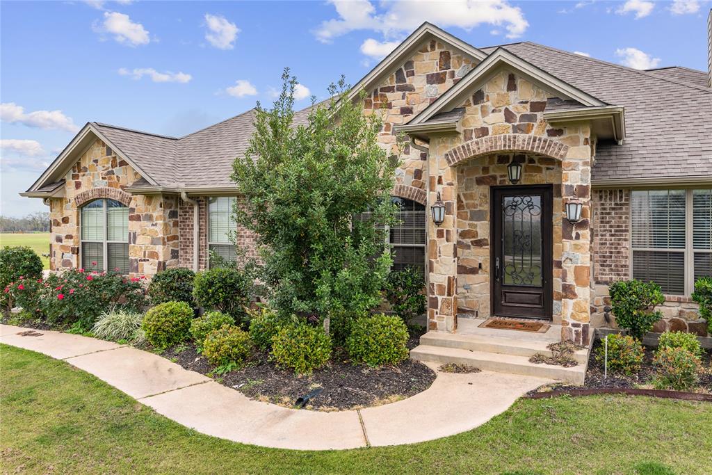 6738 C6 Ranch Road Bryan, Texas Stunning home nestled on 1.69 acres of breathtaking views in prestigious Sunrise Estates! Offering over 2,100 sqft, the many features and details make this open concept home a must see including tile cut stained concrete floors, vaulted tongue and groove ceilings, floor to ceiling stone fireplace & cedar beam tray ceiling in the living room, tankless water heater, 2" wood blinds throughout and invisible fence around the perimeter of the property. The Chef’s dream kitchen is equipped with a stainless appliances, custom cabinetry, gorgeous granite counters, island & a pot filler above the gas range. Large master bathroom with walk in shower, high end jetted tub, hidden outlets in the vanity and walk in closet with built-ins. Entertaining in the backyard is easy with the over-sized covered patio and outdoor kitchen. The extras in this home are ENDLESS! Awesome country setting conveniently located close to town! Call for a private tour TODAY!