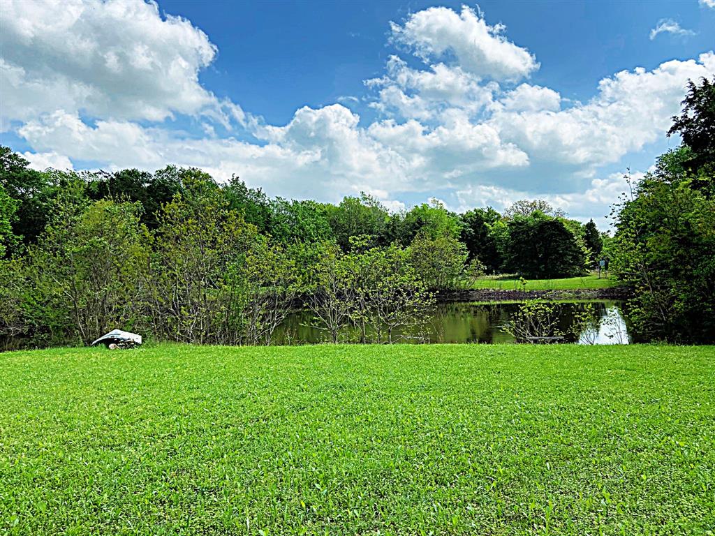 165 Happy Hollow Road Brenham, Texas Awesome wooded tract with large pond close to Brenham on approximately 22.75 acres. Secluded, shady and private. Close to Hwy 290 for commuting to Houston or Austin. Between Brenham, Burton and close to Round Top. Ranch style home with approximately 2,336 square feet, has nice yard and patio area, outdoor storage sheds and shop for your outdoor equipment. Features include: sunken den overlooking back of the property, island kitchen, large living area, 2 car garage. With a little remodeling could be a gorgeous ranch house. Great location close to Brenham for shopping, schools and medical facilities. Owner to keep minerals and waive surface rights. Ceiling fan in sun room excluded.