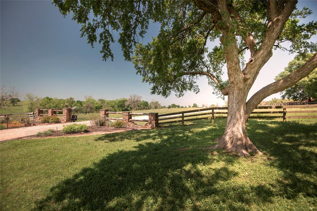 4005 Running River Lane Washington, Texas 32.8+/- acre estate is located in Doe Run & has rolling terrain w/ scattered trees, stocked pond, tree-lined creek w/ all-weather crossing, large barndominium w/ 1 bedrm living quarters & separate 2 bedrm guest house. Both the living quarters & guest house boast high-end finishes: Alder wood doors, long leaf pine floors, travertine tile, high ceilings w/ a stunning barrel ceiling in the guest house. The 1449 SF living quarters has a full-size kitchen w/h large dining island open to the living area. The 1620 SF custom guest house has 2 bedrooms w/ Jack & Jill style bathrm, office, kitchenette, & storage room. The “barn” is finished out w/ wood/metal walls, stained wood ceiling & exposed rafters and a “cantina” for social gatherings. The guest house and barn are situated back from the pond leaving the ideal build site for a future main residence. In addition to the protective covenants, Doe Run also provides access to a 16-acre community river park with frontage on the Brazos River.