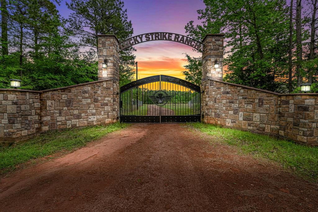 1401 County Road 779 Douglass, Texas Lucky Strike Ranch is situated in Douglass, TX which is conveniently located only two hours from Houston and 2.5 hours from Dallas and just a stones throw from Nacogdoches. This 415-acre High Fence ranch is truly turn key and is LOADED with amenities. Lucky Strike offers genetically enhanced White Tail Deer, Axis and Red Stag hunting with stands and food plots in place. The lodge is equipped with 4 Bedrooms, three full baths, commercial grade kitchen, study/work out room two story custom fireplace, large bar and gaming area which is perfect for entertaining. All necessary equipment for the ranch will be conveyed and is housed in the oversized shop. Other included features are Walk In cooler, whole house generator, home furnishings, automatic gate, Stands and Feeders and so much more! In addition, the rich pine plantation can offer a secondary source of income for the ranch. Call to schedule your private viewing today!