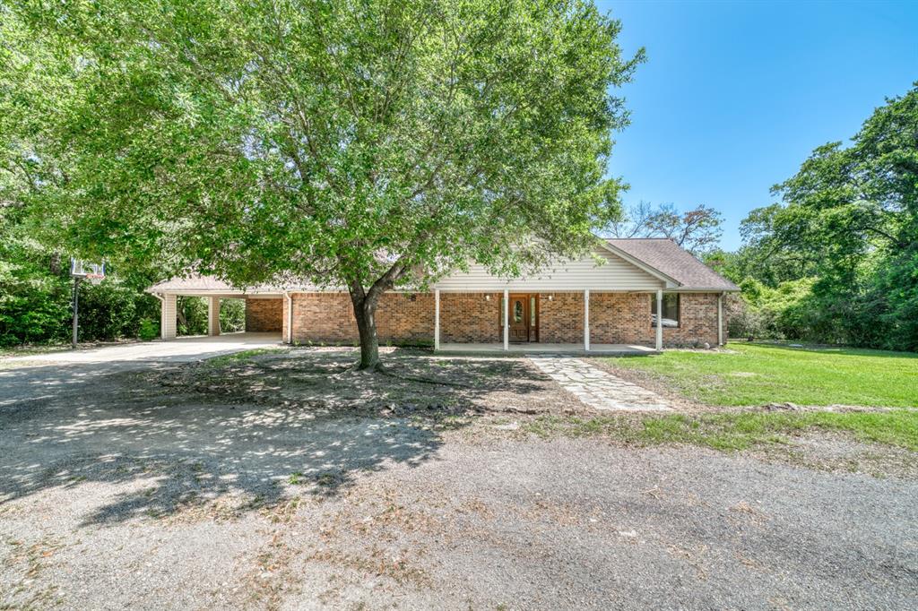 1538 Wildwood Lane Madisonville, Texas 3 bed 3 bath home in the highly sought after Oak Forrest subdivision in the Madison County school district. Sitting on 1.5+- acres surrounded by huge oaks you would never know you had neighbors. There is an attached carport along with an outside closet for plenty of storage. There is a large living room with tall ceilings making the home have a neat open concept. The house has good bones and is a solid built home, however there are some updates needed. The home is being sold As Is.