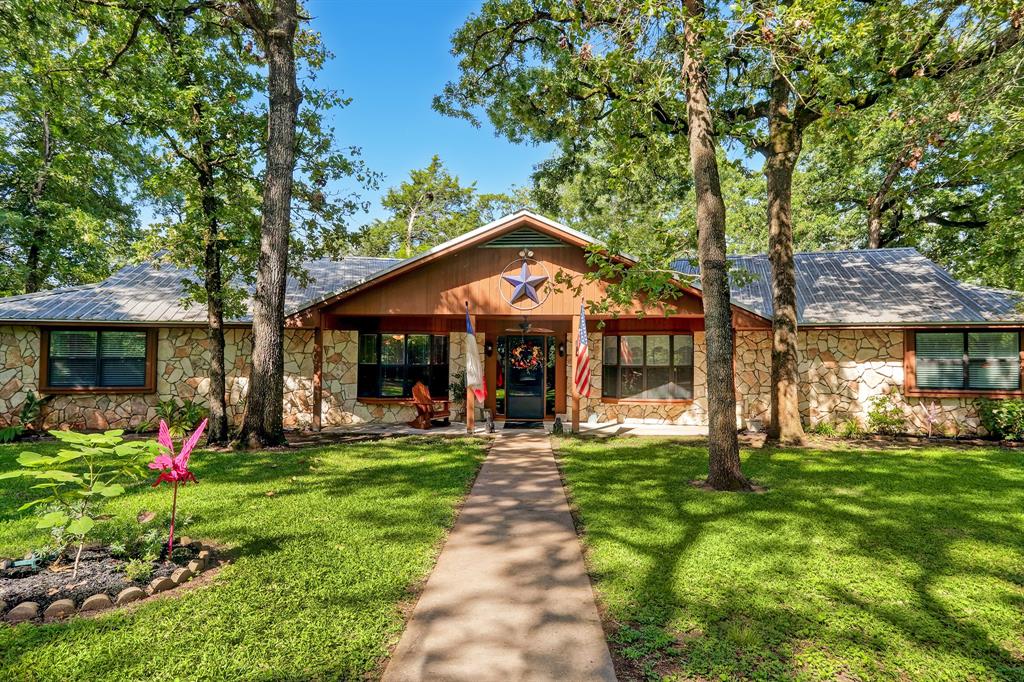 155 Oakwoods Drive Bellville, Texas Beautiful One story 3-3-2+ Bonus room w/oversized garage (w/workshop/storage), situated on a 2.69 acre heavily wooded secluded lot. Home appx. 3300 sq ft. Large family room is open to kitchen & breakfast rooms. Windows along back wall provide view of park- like backyard. Recently updated kitchen has granite, s/s convection oven, new stove & dishwasher. Tons of cabinet space /large pantry. In 2017, a spacious (19x20-L shaped) bonus room was added. Master bedroom, 15 x 17, has 2 walk- in closets. Master bath has dual sinks & glass step-in shower. Secondary bedrooms have walk-in closets. 1 bdrm has direct access to the 2nd bath. Floors are primarily durable PVC material. Large covered patio 26x32 - made for family fun & outdoor activities. Manicured lawn surrounds home, beyond that is surrounded by trees & nature at its finest. 2 car garage has additional 15x30 workshop, plus a storage room. There’s also an 18x25 covered boat storage & plenty of additional parking for all your toys.