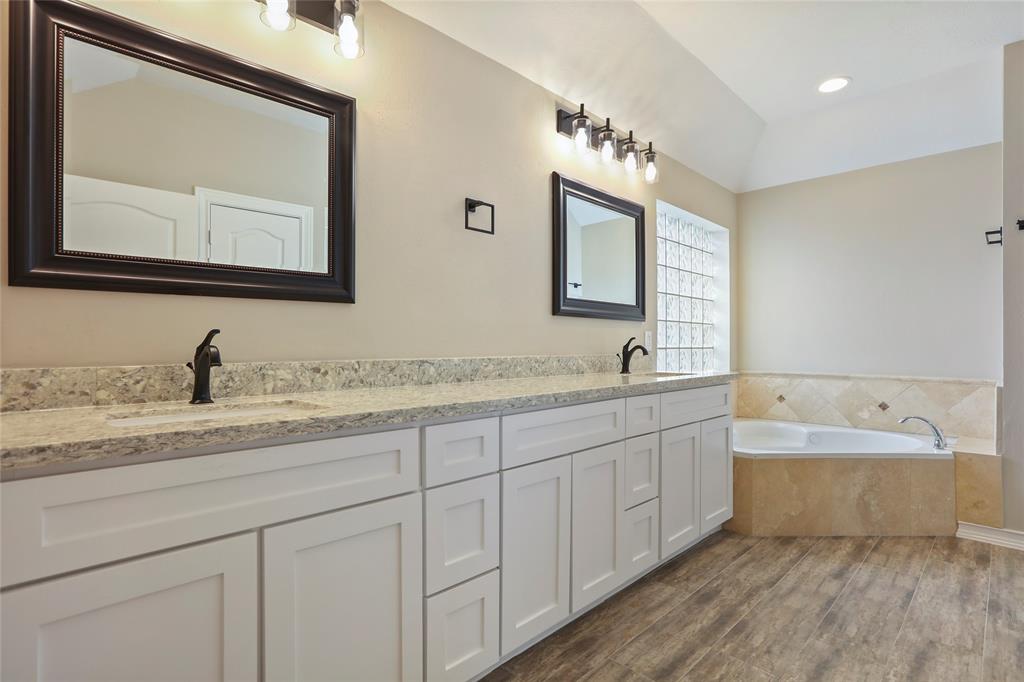 The freshly renovated master bathroom features the same high quality porcelain, shaker cabinets and luxurious quartz countertops found throughout the house. The whirlpool tub will melt the stresses of life away.