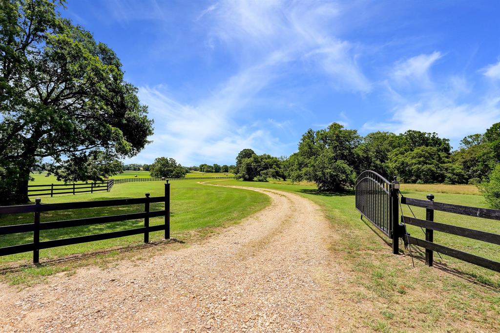 8508 Coles Road Brenham, Texas Historic Washington County beauty! Own a piece of history with this gorgeous 80-acre property in Independence.
Home has high ceilings, original hardwood floors, windows, doors, all meticulously maintained/restored. Currently front 2 rooms are used as a formal living room and office. The next 2 rooms in original part of home utilized as 2 bedrooms. Upstairs is a large room with 1/2 bath which could be another bedroom, playroom, bunk room.
Kitchen/breakfast area open to large den w/stone fireplace, built-ins, French doors opening to large covered porch overlooking grand oaks and seasonal creek.
Large downstairs master w/abundant storage: 3 closets + built-ins. Master bath has large soaking tub overlooking woods, a separate shower, and a double vanity.
Lovely hay pastures scattered w/absolutely gorgeous century oaks and pond. A deep ravine leads to seasonal creek which affords setting for abundant wildlife.
80 mi from Houston, short drive to Brenham.