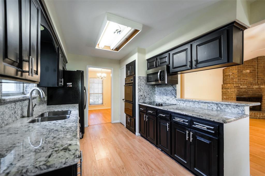 Handsome, shining updated kitchen. Storage for pans etc. Dual sink. SS fridge comes with the house.
