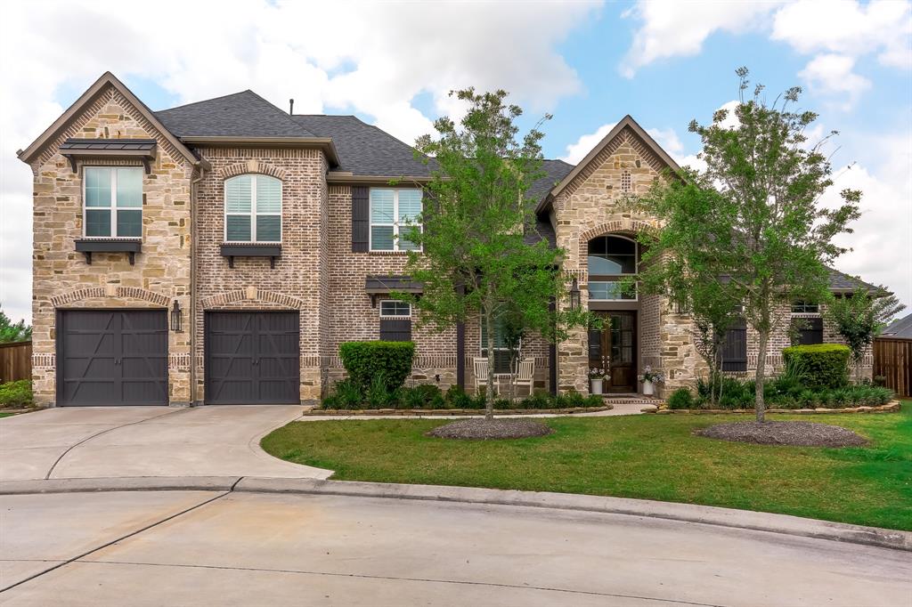 27610 Horn Breeze Lane Spring, Texas This immaculate 2 story home is located in the gated section of Benders Landing Estates. This designer's dream home features an elegant 2 story foyer with custom 9 foot wainscoting leading to the curved staircase, living room, soaring ceilings, and floor to ceiling stone fireplace. Welcome your family and friends around the oversized kitchen island while your favorite chef cooks gourmet meals with the GE Monogram appliance package. Large master retreat features plenty of space for a sitting area, custom wainscoting on an accent wall, his/her vanity areas and a 16' long shower with 3 shower heads, and a soaking tub! Tucked on the opposite side is a much desired 2nd bedroom with ensuite bath featuring a walk-in shower. The beautifully painted curved staircase leads you to a large gameroom, media room, 2 bedrooms with large walk-in closets, 2 bathrooms, and a large walk-in attic space. Wind down each night on the covered back porch and imagine how you could customize your new backyard.