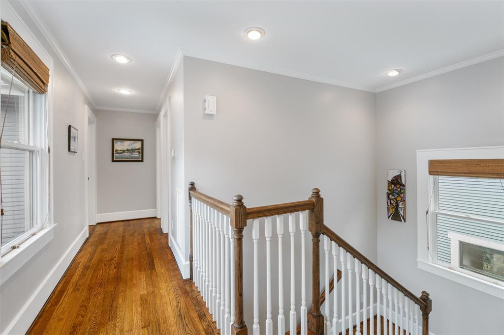 The landing at the top of the stairs features a row of windows that provide great natural light.