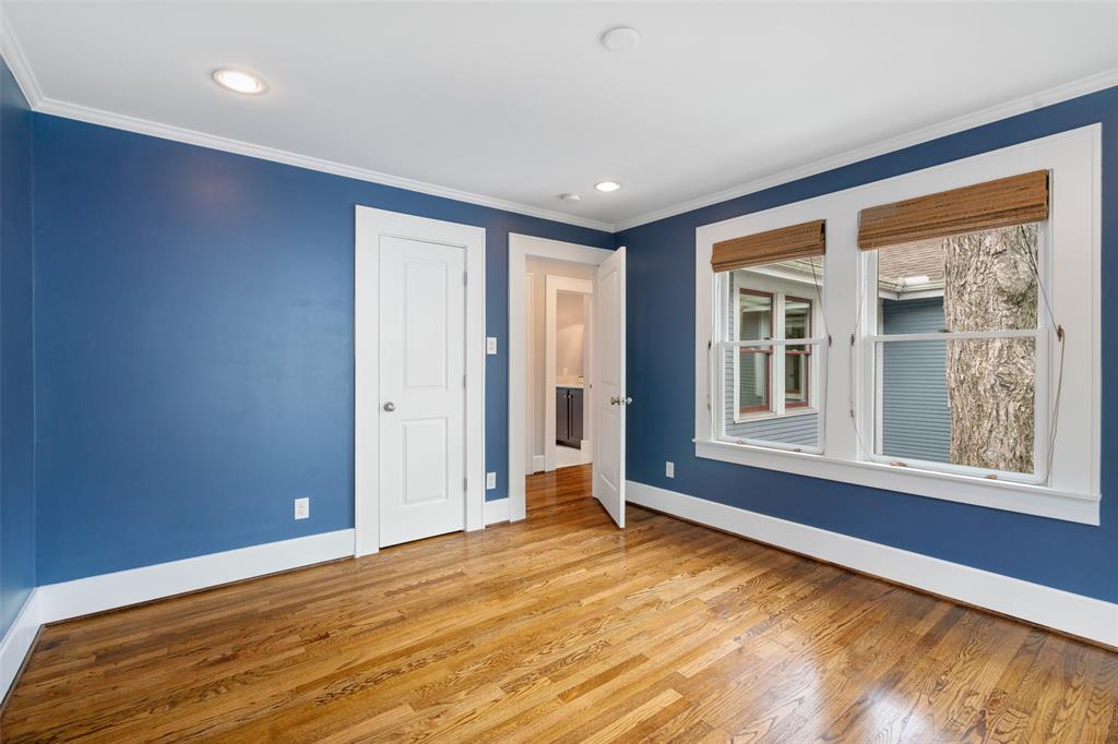 Each of the upstairs secondary bedrooms features large windows and hardwood floors.
