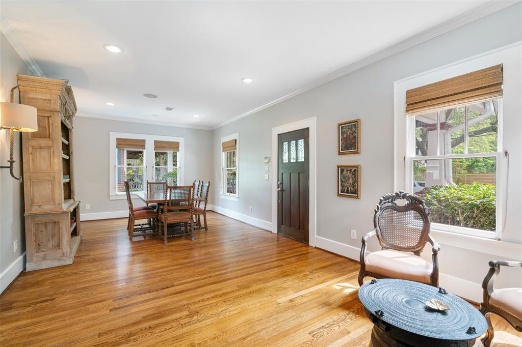 Your guests will be welcomed into this large receiving area. The space to the right is currently being used as a dining room, but this space is very flexible. This room, like most of the house, includes gorgeous oak floors, recessed lighting, crown molding, and like the front porch is wired for sound through the Home Automation system.