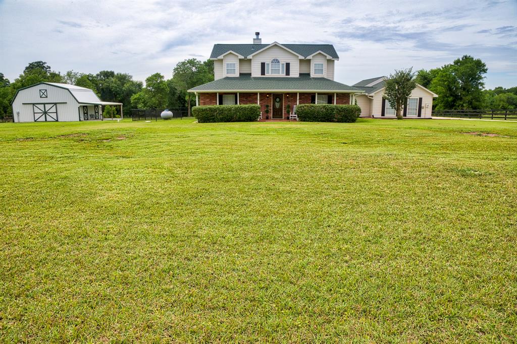 8538 Rolling Oaks Drive Montgomery, Texas Welcome home to country living at this beautiful estate in Rolling Oaks. This two story home sits on over 5 acres, with a 3 car carport, Pool/spa, outdoor kitchen, approx. 1/4 acre pond, 24x36 wood frame metal building on slab with 10x15 tack room and a/c. A Mr. Mister mosquito system has been installed for those summer nights out on the patio. Master bedroom is located on the first floor, as well is a huge bonus room. This home is immaculate and a must-see! Upgraded features: Wood ceramic tile throughout 1st floor, kitchen updates completed in 2012, Complete Master Bath renovation in 2017, New roof 2018, New a/c in 2010, 2 car garage was converted into a living space that can serve as a bedroom, playroom, home gym or office space, New beautiful black wood fence was installed in 2019.
