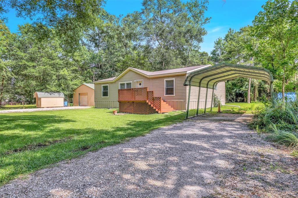 9081 White Oak Drive Conroe, Texas Commercial & Residential Options on this UNRESTRICTED 1/2 acre property located at the entrance to Carriage Hills and Jacob's Reserve and just minutes from The Woodlands, Spring, Conroe, & Magnolia. Well kept and clean manufactured home that would work well as an office space, or live here and use the other buildings for your small business. 720 sq. ft. warehouse with industrial racks and front and rear garage doors makes a great workshop or storage space. Small shed can be used for office space or storage. Incredible location with easy access to I-45.