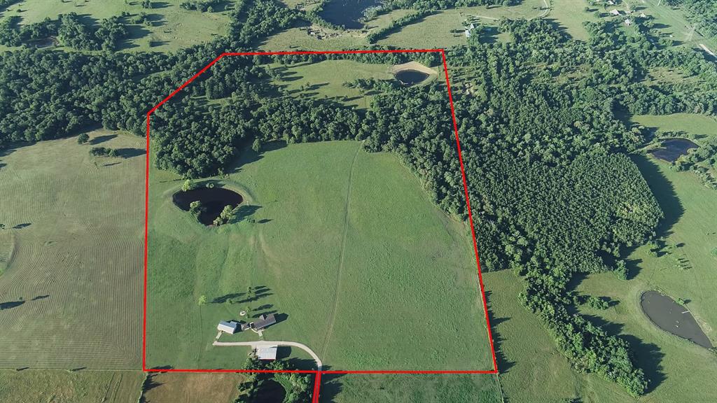 6580 CR 313 Navasota, Texas Haynes Farm - Almost 74 acres in the rolling hills of southern Grimes County. Mostly hay pasture so ag. exempt. Two ponds each with a windmill. Band of trees along Sand Creek offers excellent wildlife habitat. Two recent Palm Harbor doublewides share a covered picnic pavilion and a firepit. 60x40 shop building provides lots of space for ag equipment and other machinery. It has power, four roll-up doors, one man-door, a concrete apron, and a water tap just outside. Water is from a public water system. Power has been brought underground so no unsightly power poles. Each home has its own septic system. 50 ft of elevation change from the highest point to the draw where Sand Creek crosses the property. Sited at the end of a long driveway, the property is quite secluded; yet offers easy access to College Station or Houston. Sellers will include all furnishings and 50% of minerals owned for the right offer. Haynes Farm is ready to welcome your family to country living.