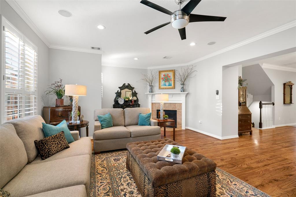 The spacious living room features wood floors, crown molding and lots of natural light. This is the perfect space to relax with your family or watch the big game.
